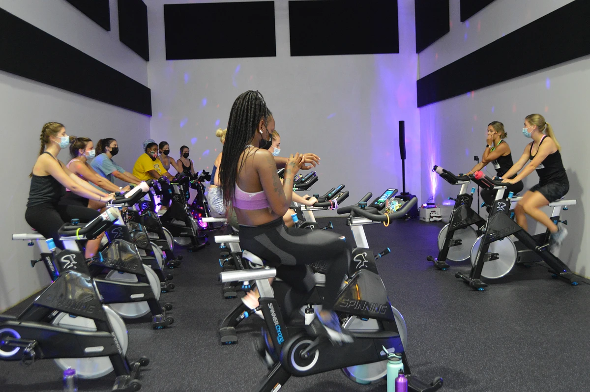 A group of students on cycling bikes taking a group fitness class 